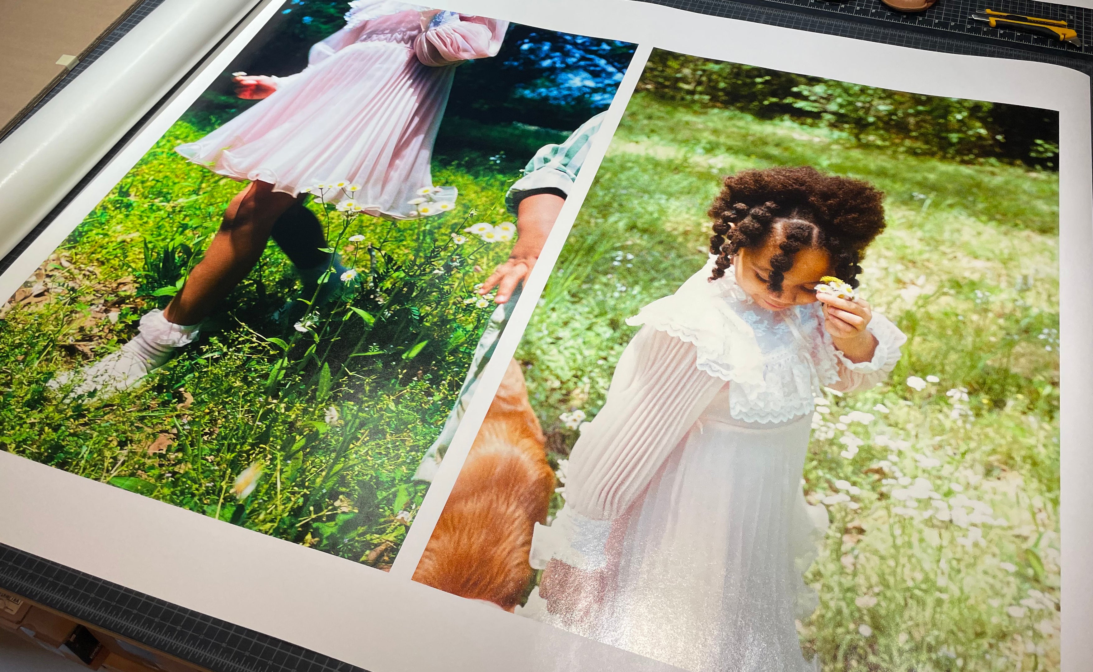 A top view of several archival prints of a girl, ready for to be cut and packaged for an exhibition