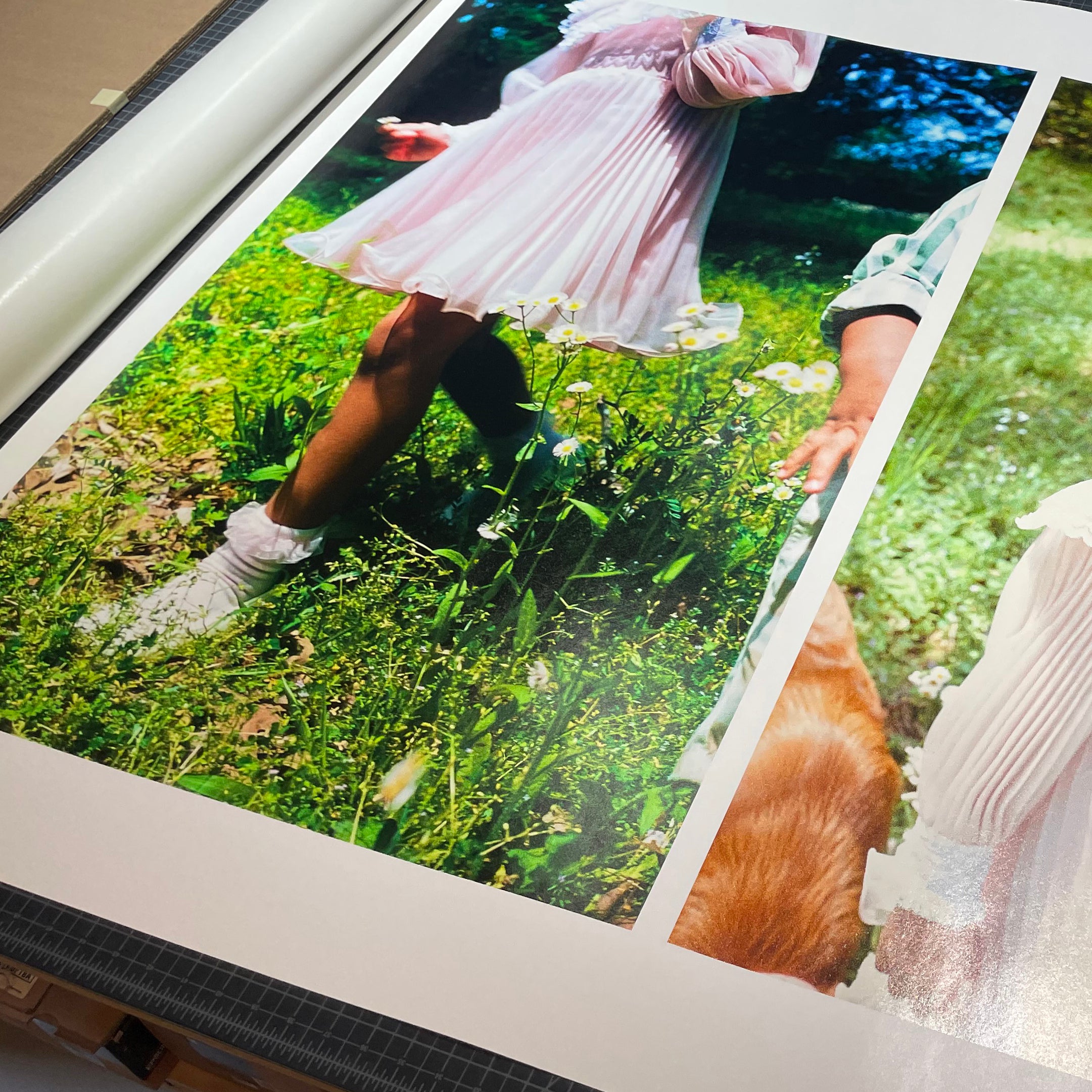 A top view of several archival prints of a girl, ready for to be cut and packaged for an exhibition